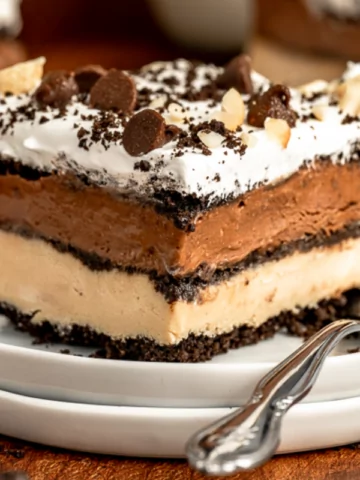 a plate of Chocolate Peanut Butter Oreo cake with chocolate chips on top