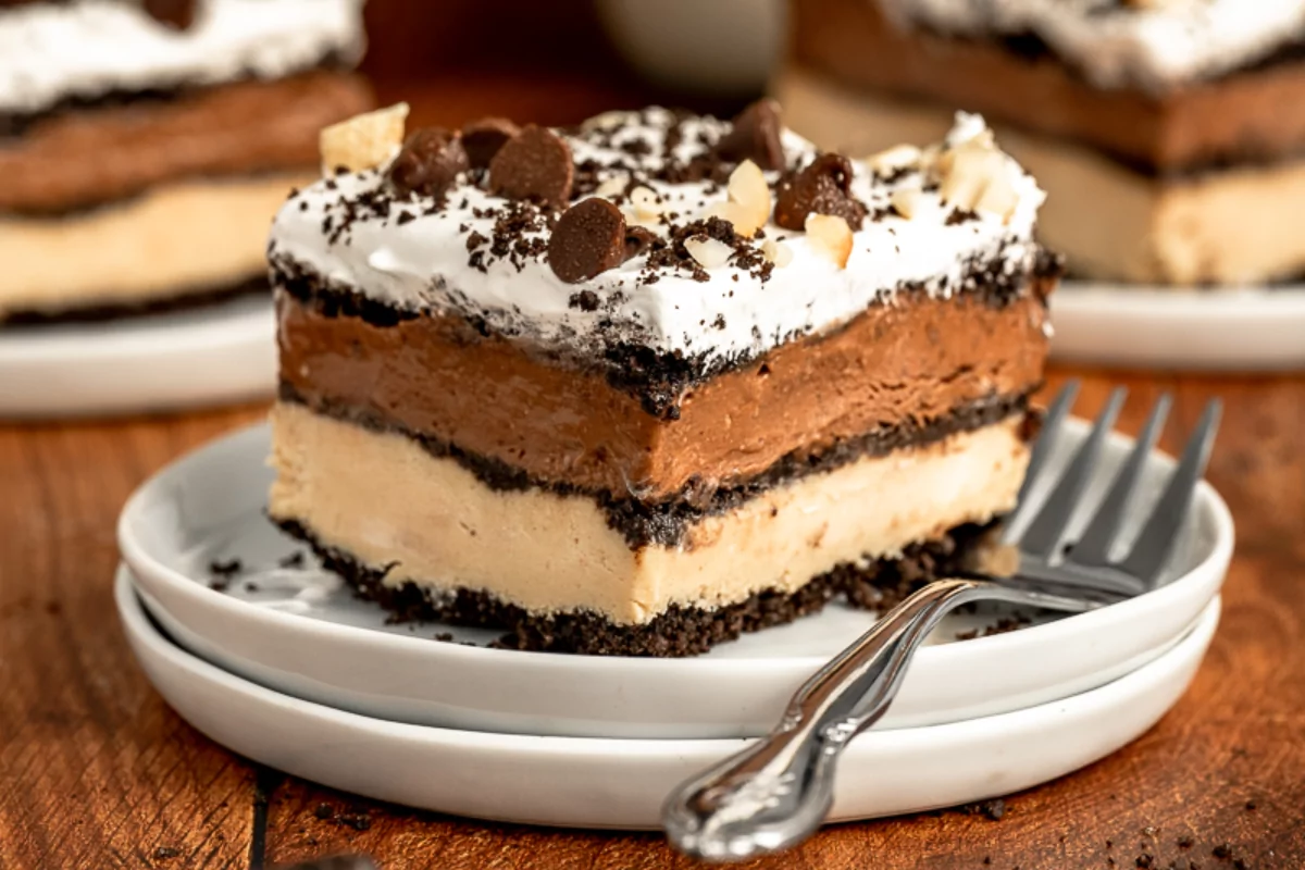 a plate of Chocolate Peanut Butter Oreo cake with chocolate chips on top