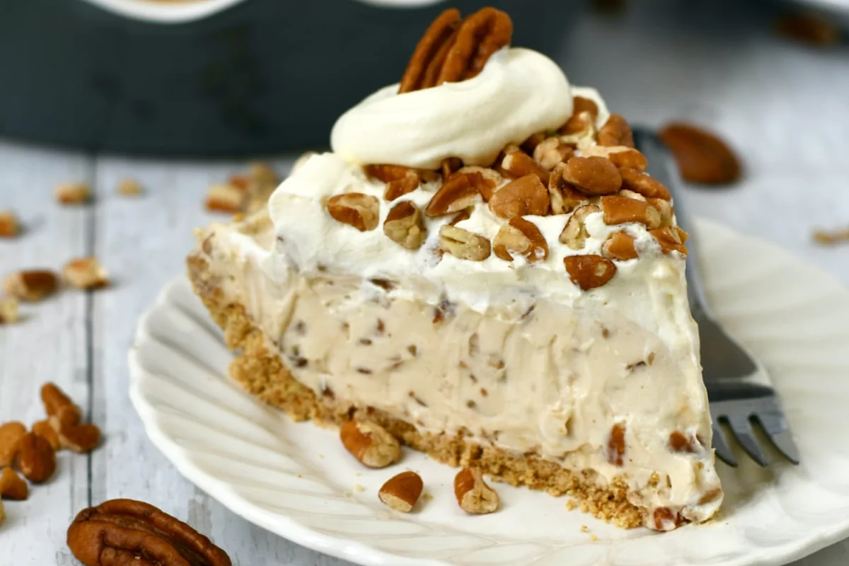 a plate of cake sprinkled with pecan on top