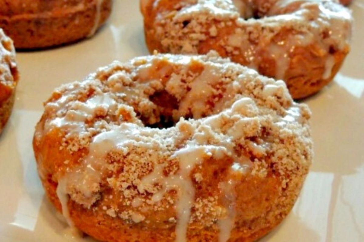 closeup pumpkin cake mix donuts with crumb topping.