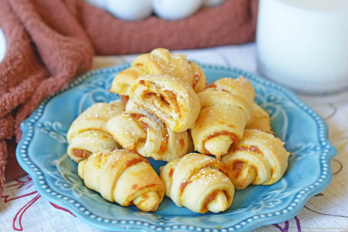 crescents filled with pumpkin on blue plate.