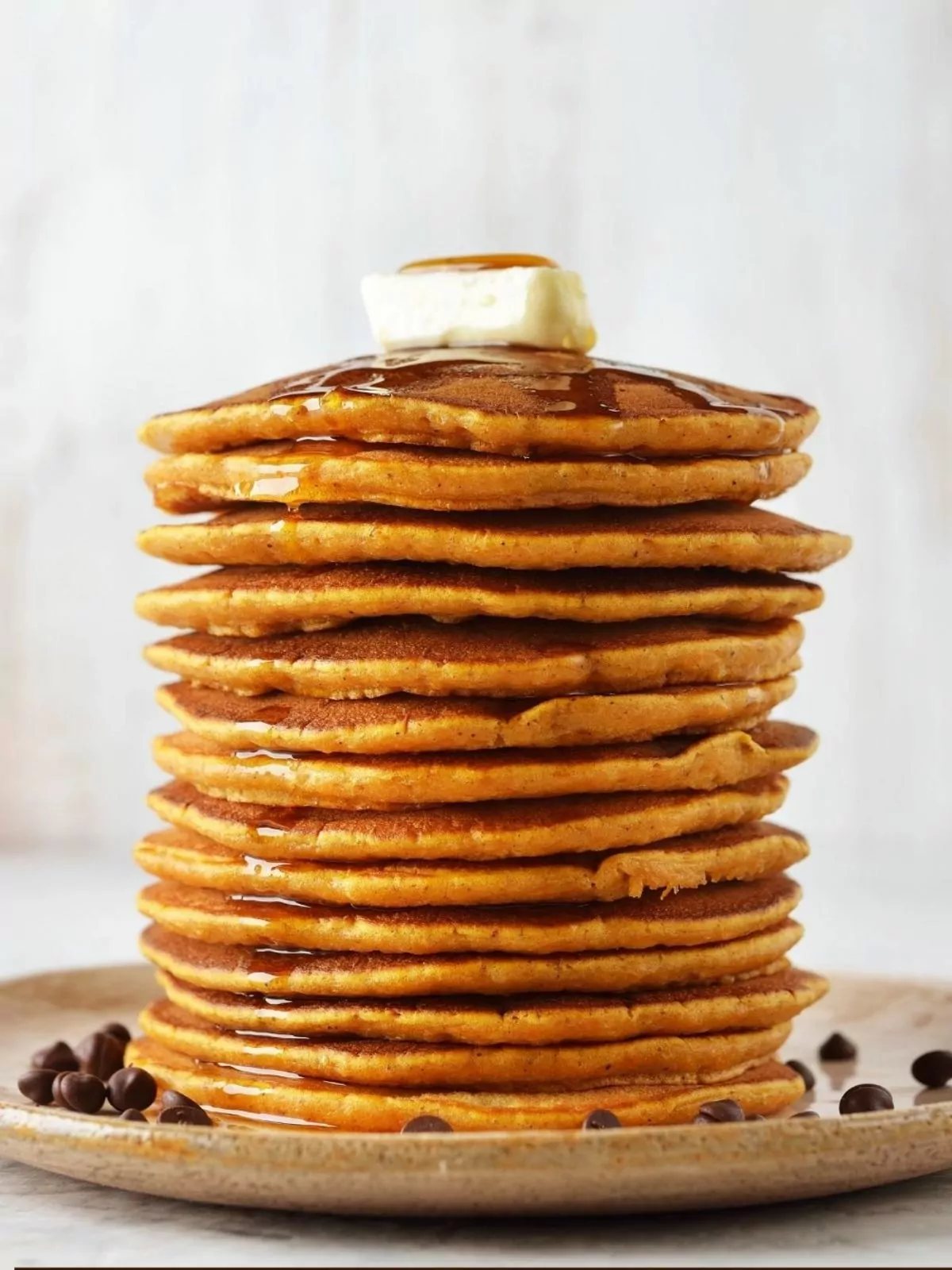 Stack of Pumpkin Pancakes with butter and syrup.