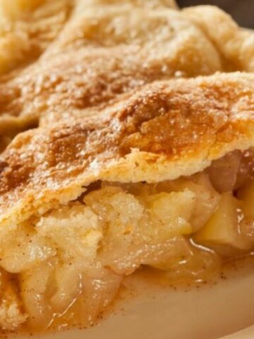 a slice of apple pie on a white plate.