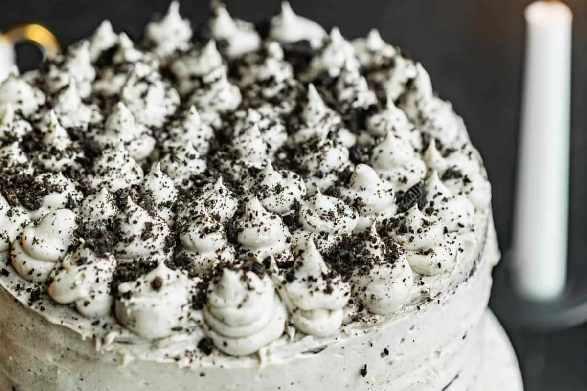 A layer cake made of black velvet cake frosted for Halloween.