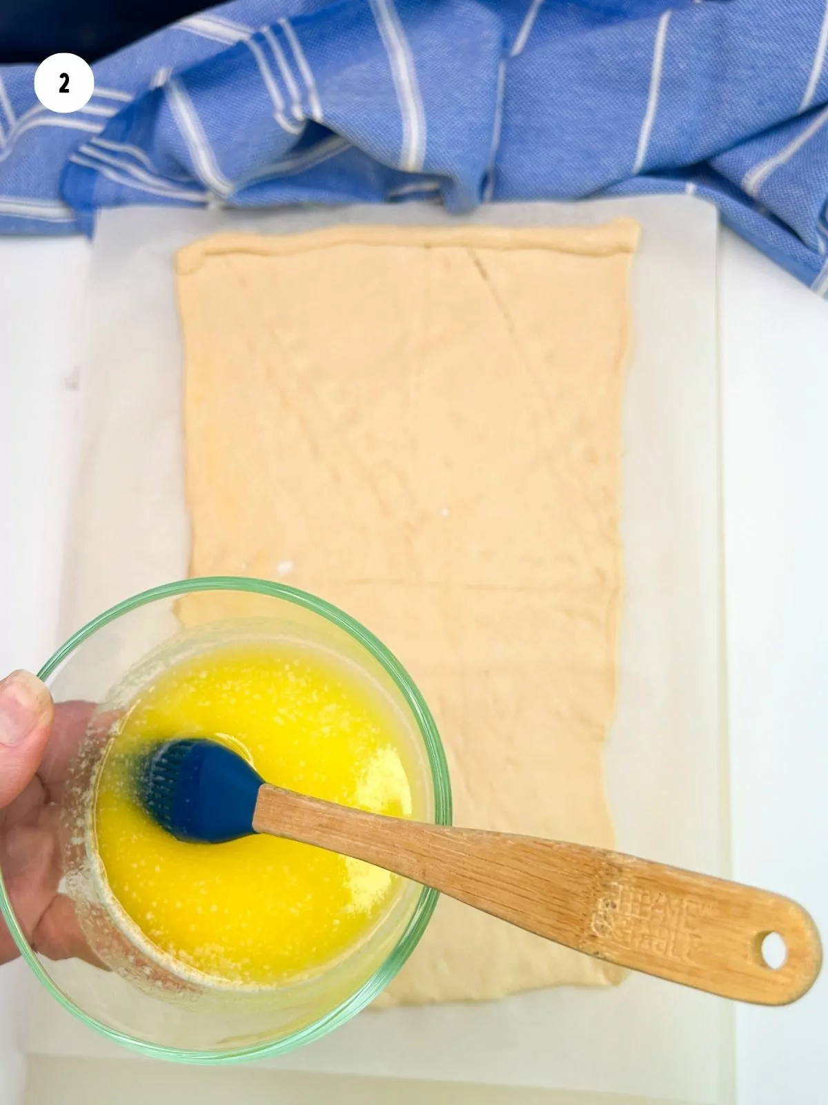 melted butter in bowl with brush.