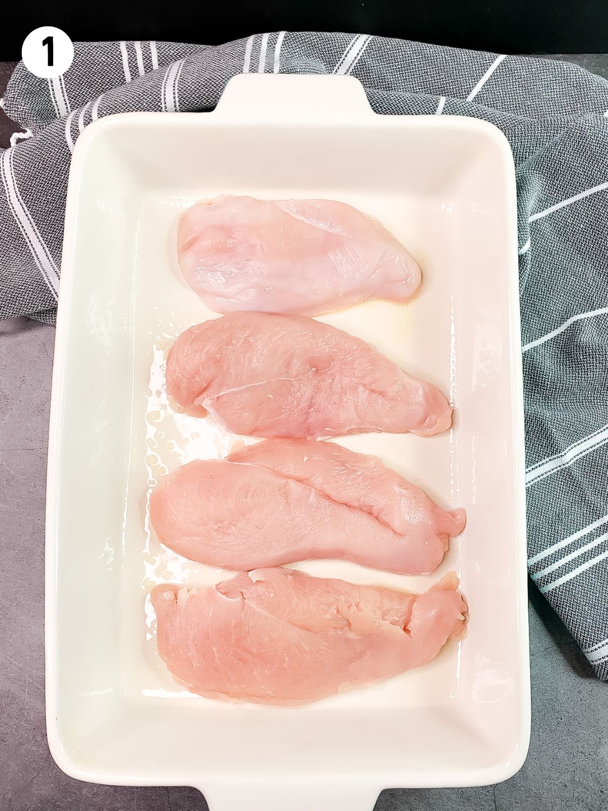 boneless skinless chicken breasts in baking dish.