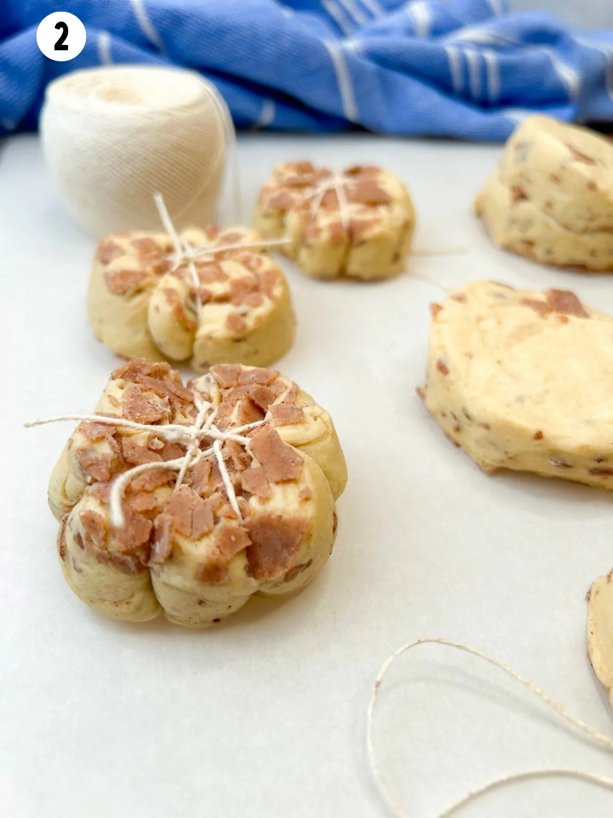 cinnamon rolls wrapped with kitchen twine.