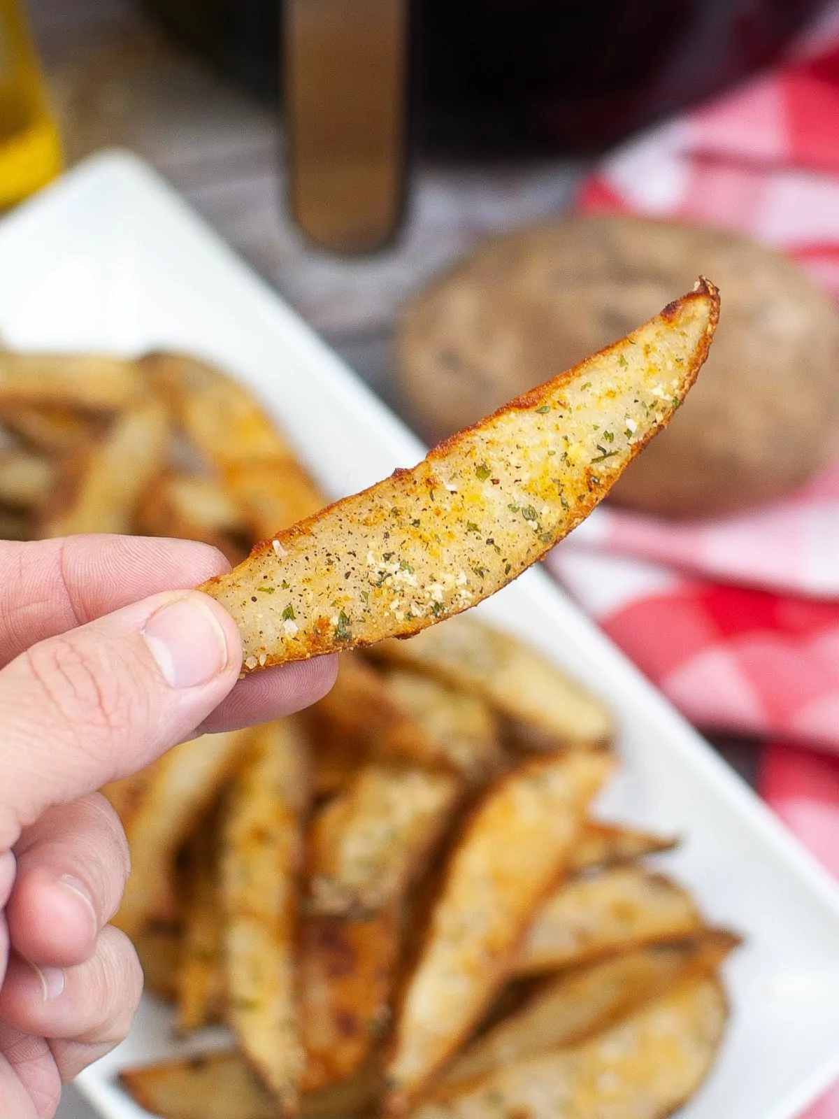 close up of seasoned potato wedge