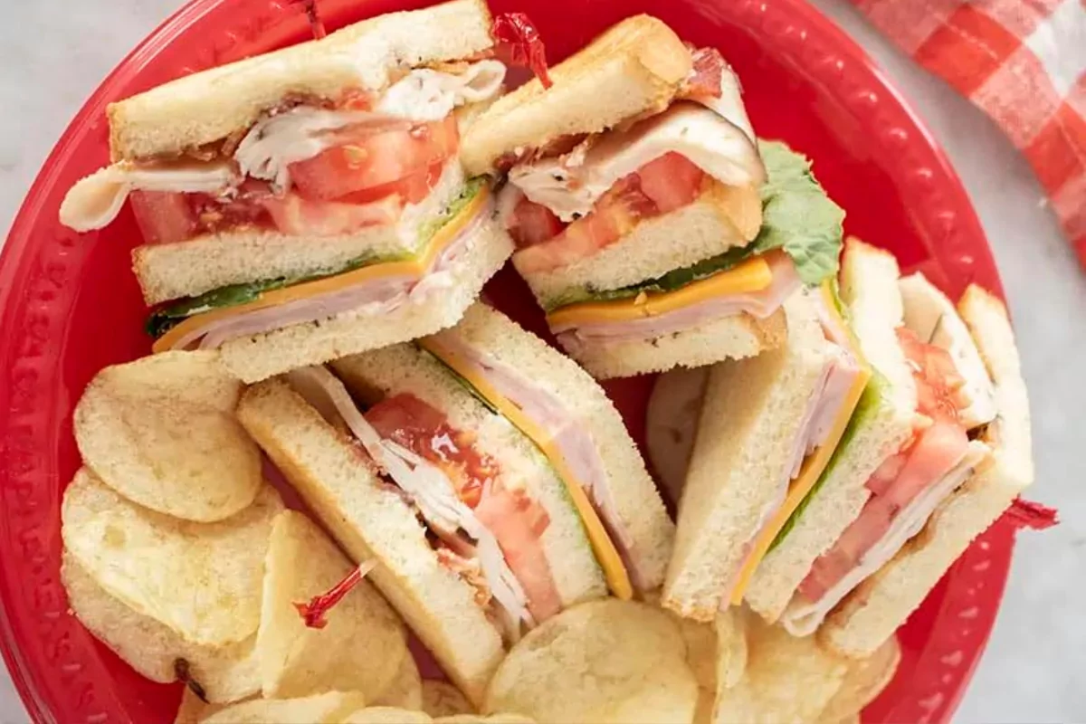 4 club sandwich with chips in a bowl