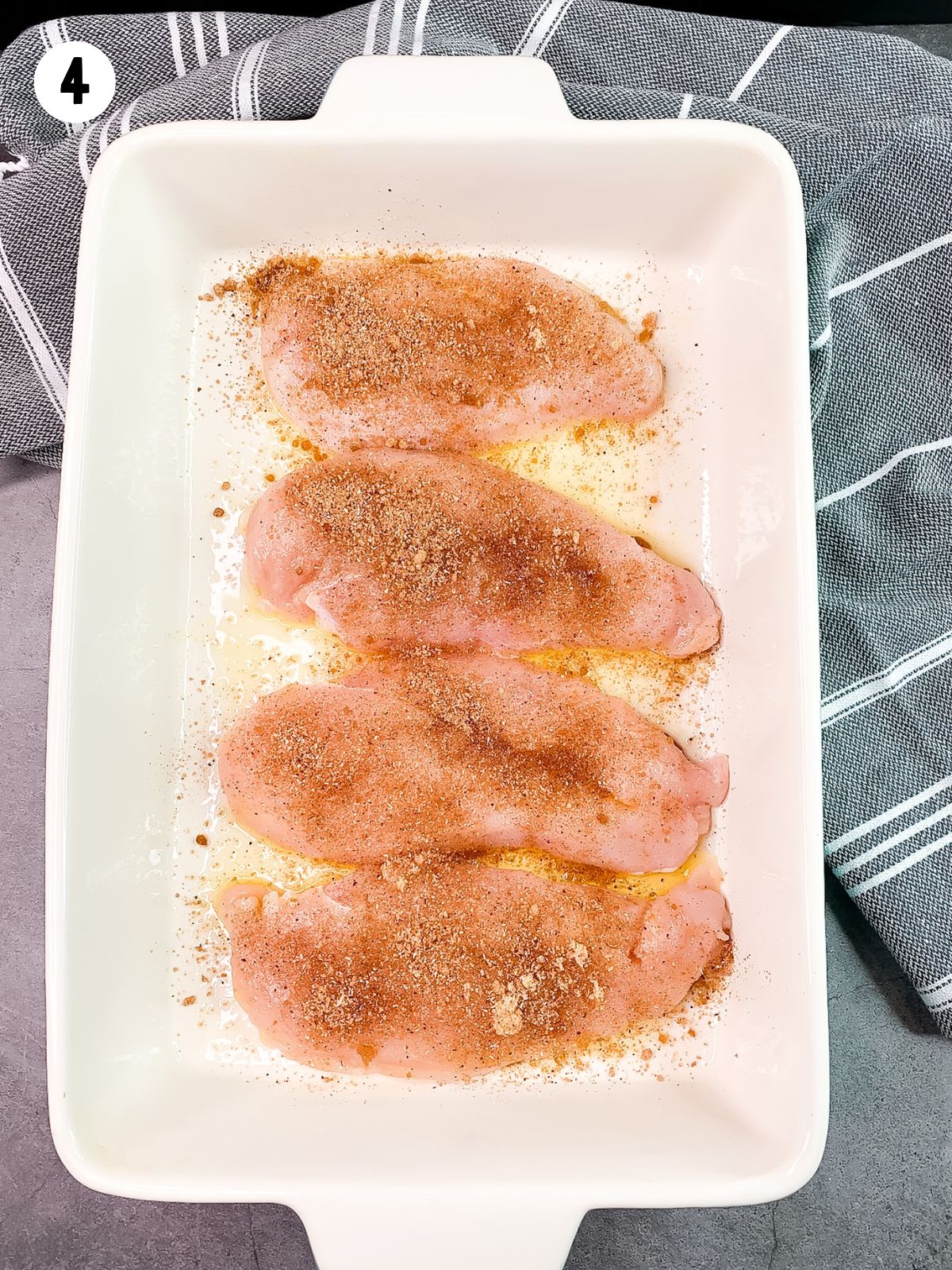 seasoned chicken in baking dish before baking.