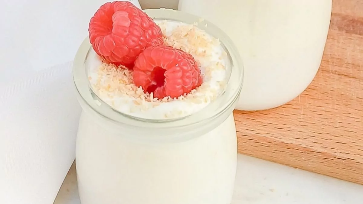 A jar of eggless mousse with a berry on top