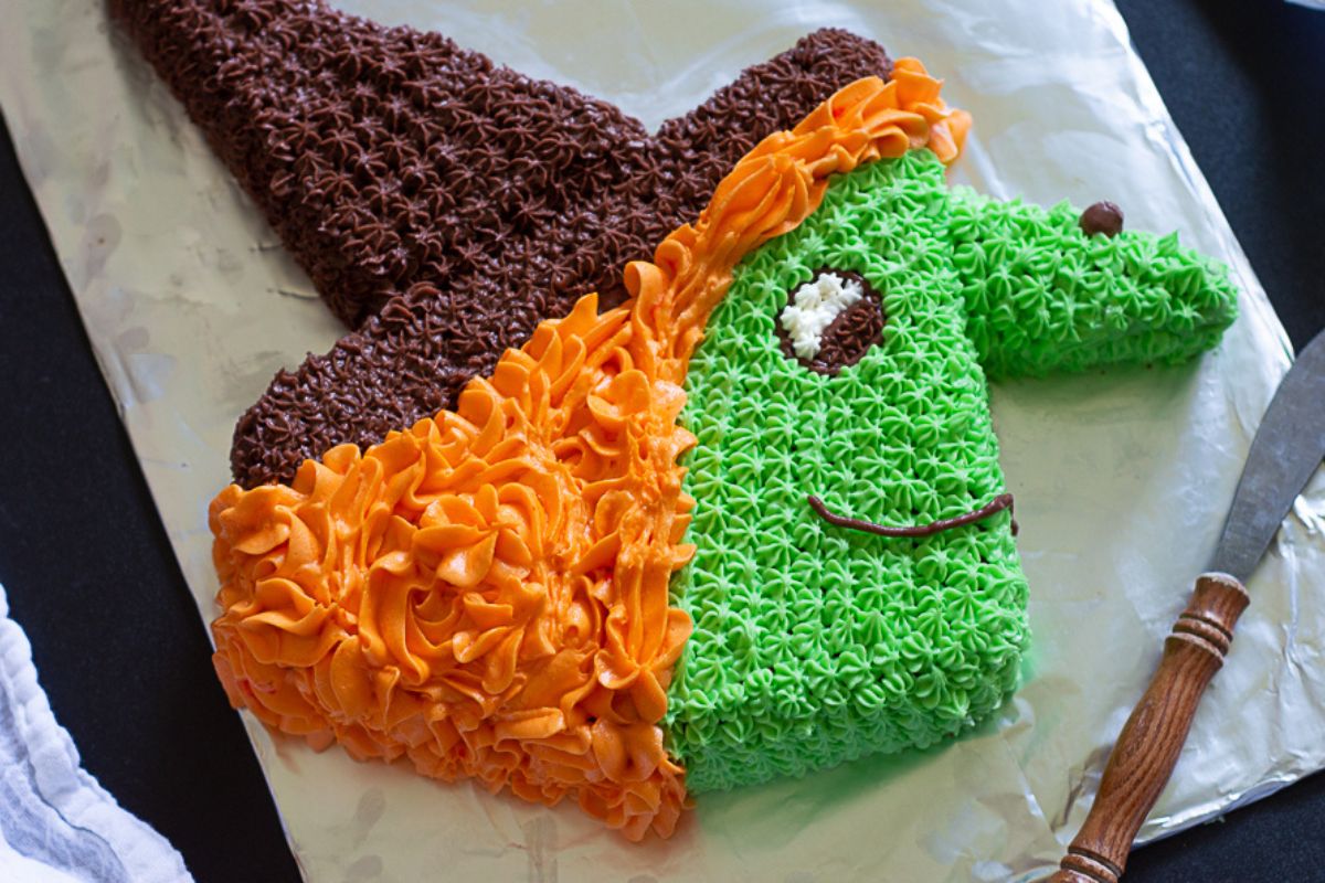 a cake shaped and decorated like a witch face for Halloween.