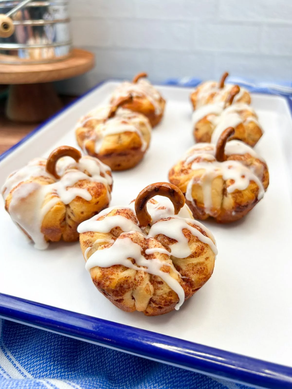 tray of cinnamon rolls shaped into pumpkins.