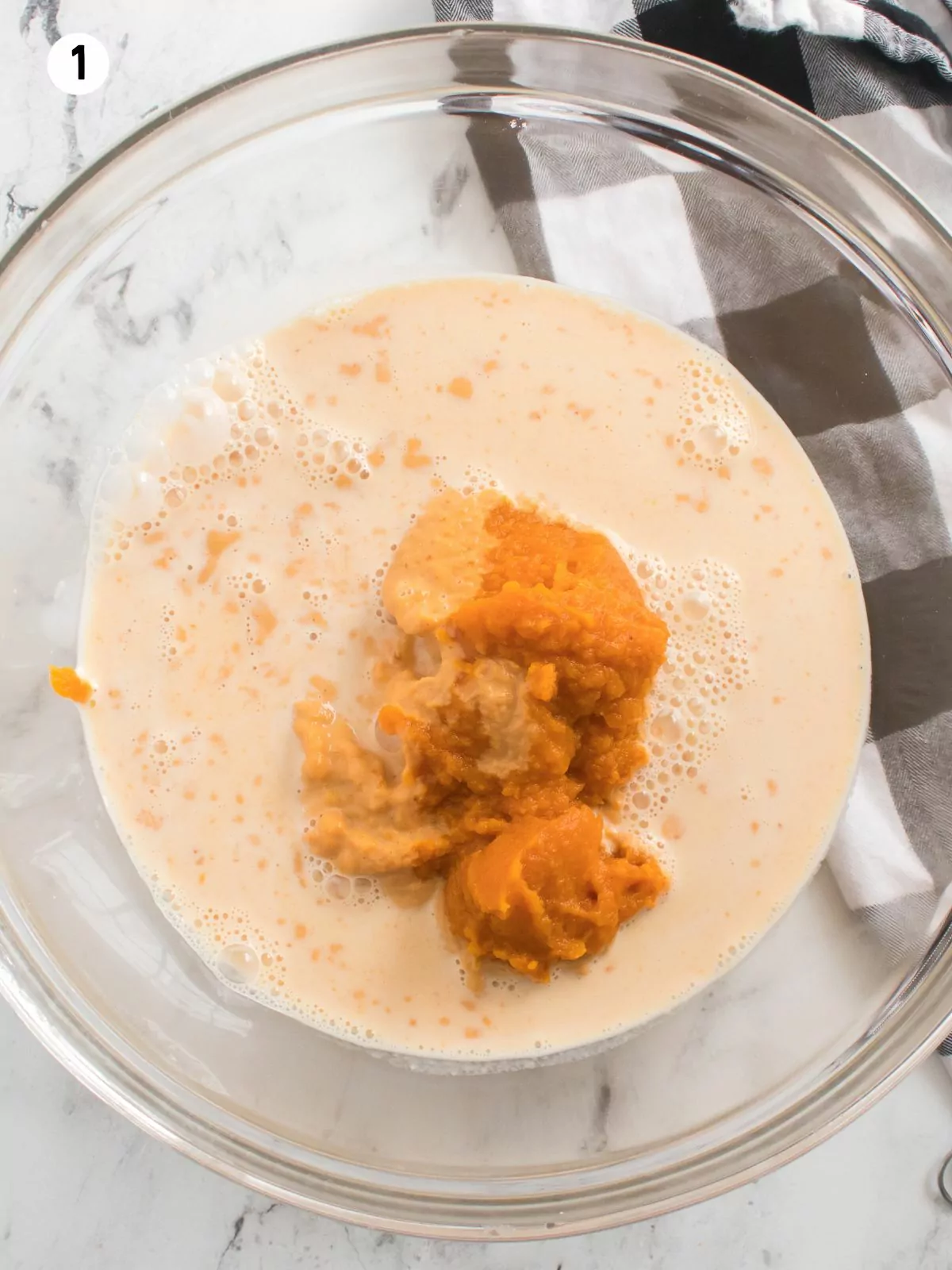 pumpkin puree, evaporated milk in glass bowl.