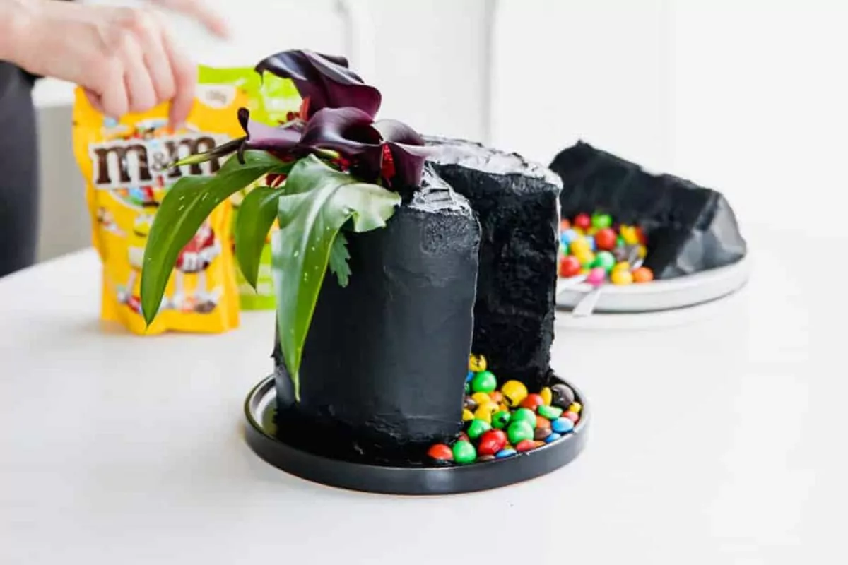 a dark black cake filled with M&M’s pinata style for Halloween.