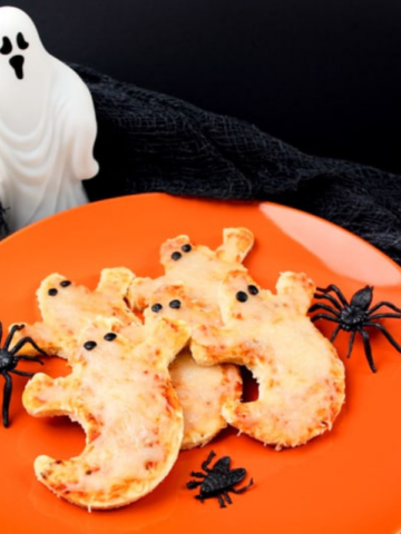 cheese pizzas made of a premade pizza crust, cut into a ghost shape.