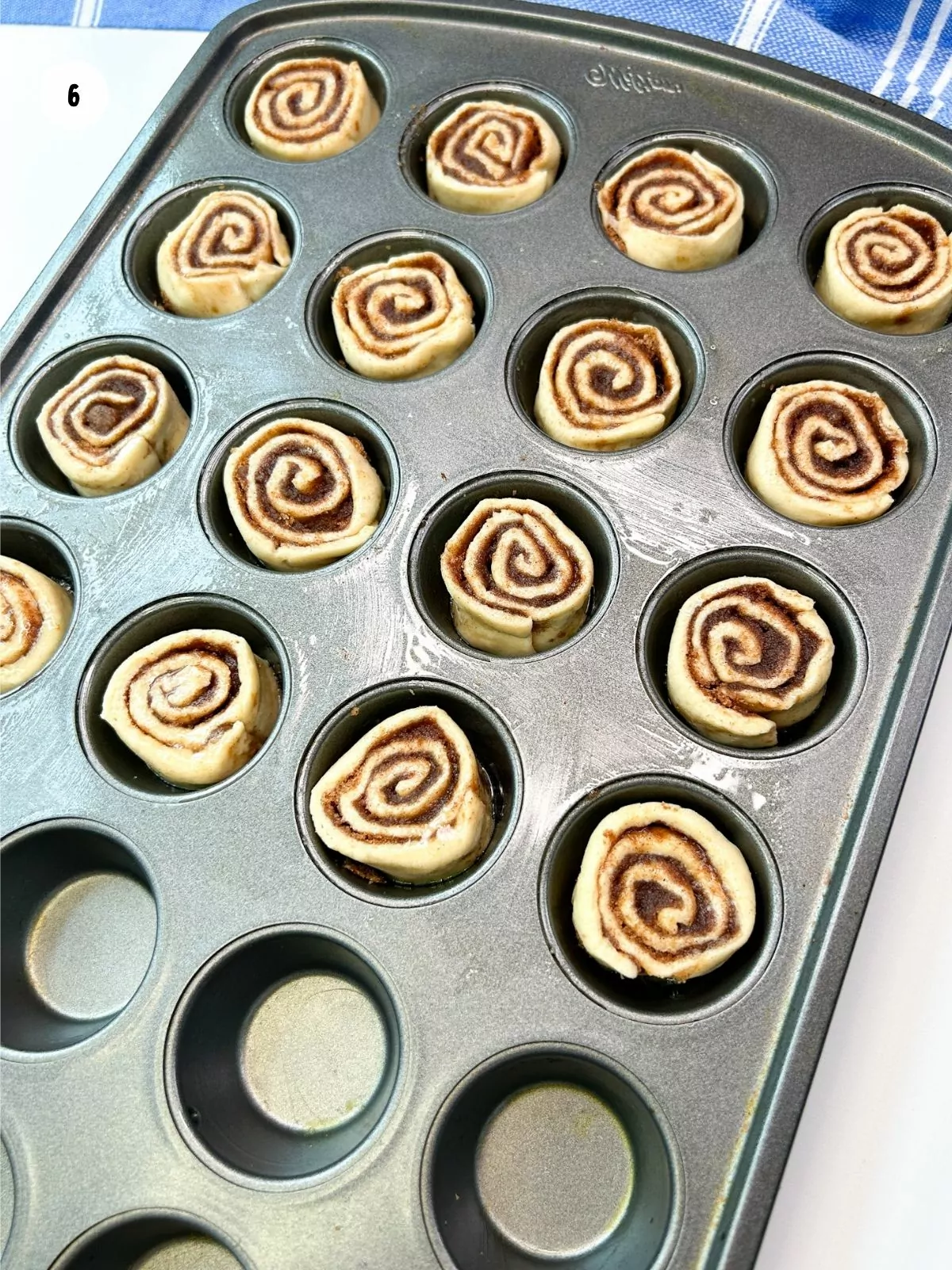 crescent roll cinnamon rolls in mini muffin pan before baking.