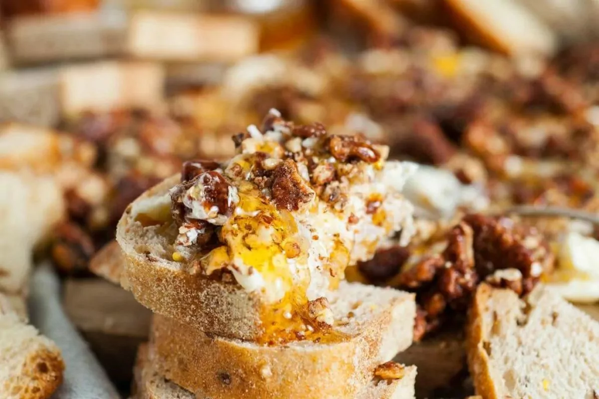 a charcuterie board with glazed pecans cinnamon salted butter