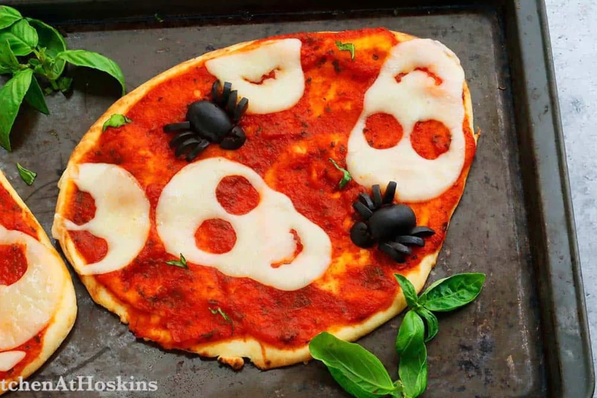 pizzas with cheesy skulls over sauce for Halloween.