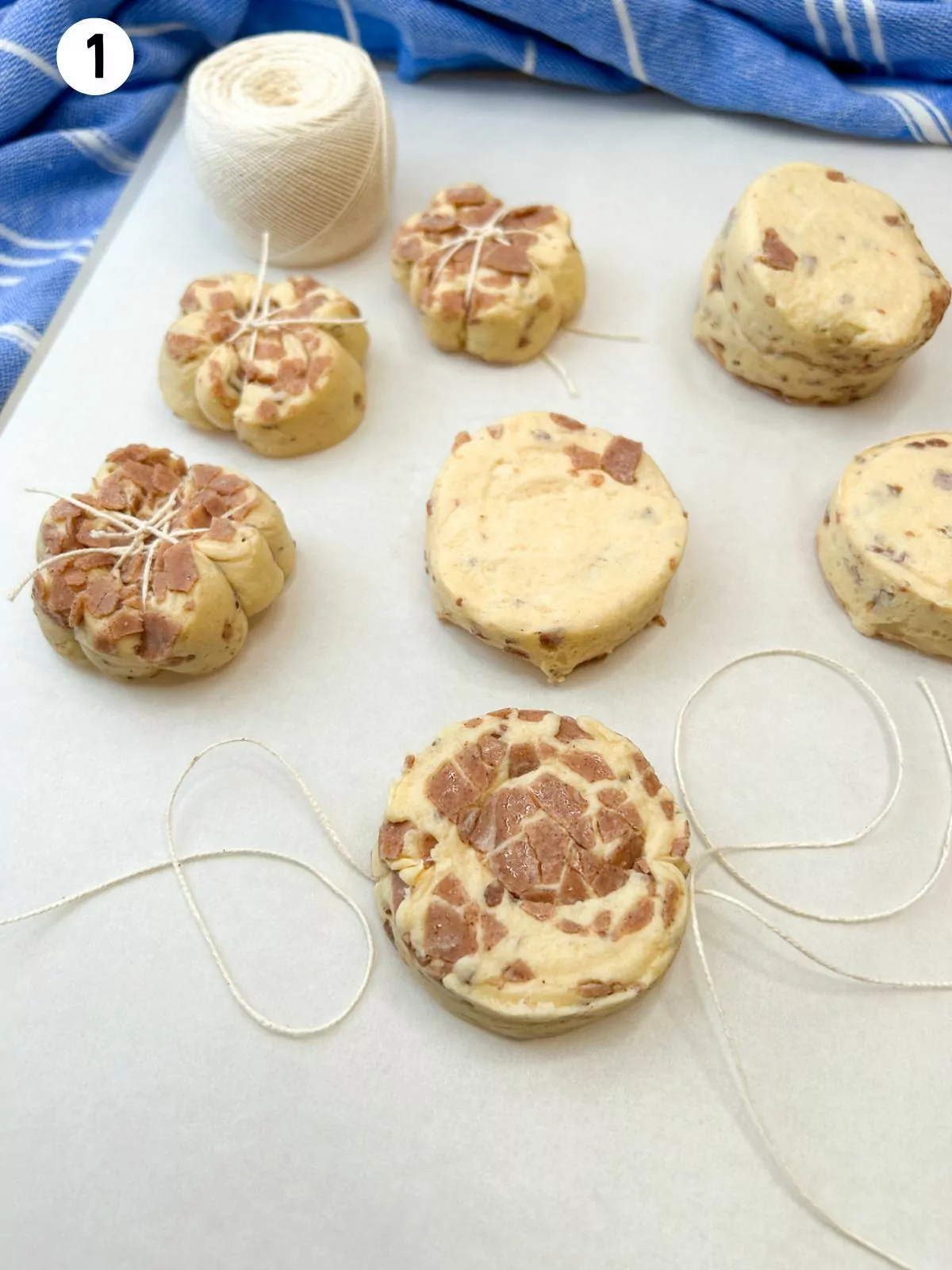 kitchen twine wrapped around canned cinnamon rolls.