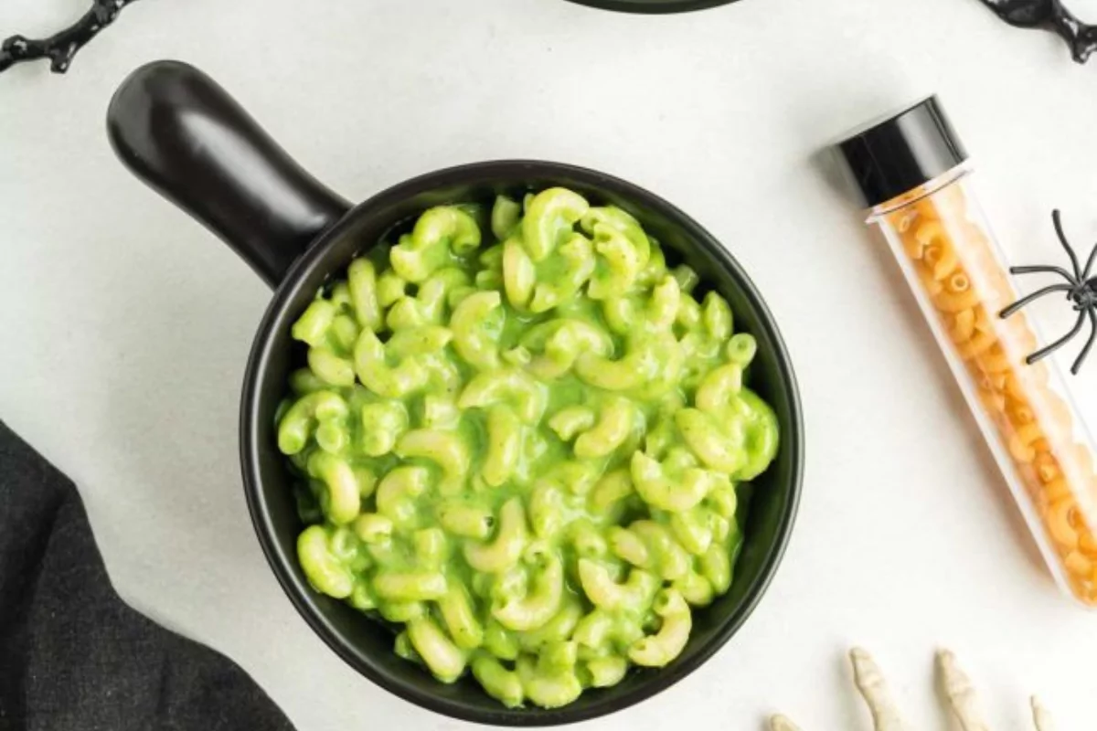 Green mac and cheese in a bowl, perfect for Halloween.