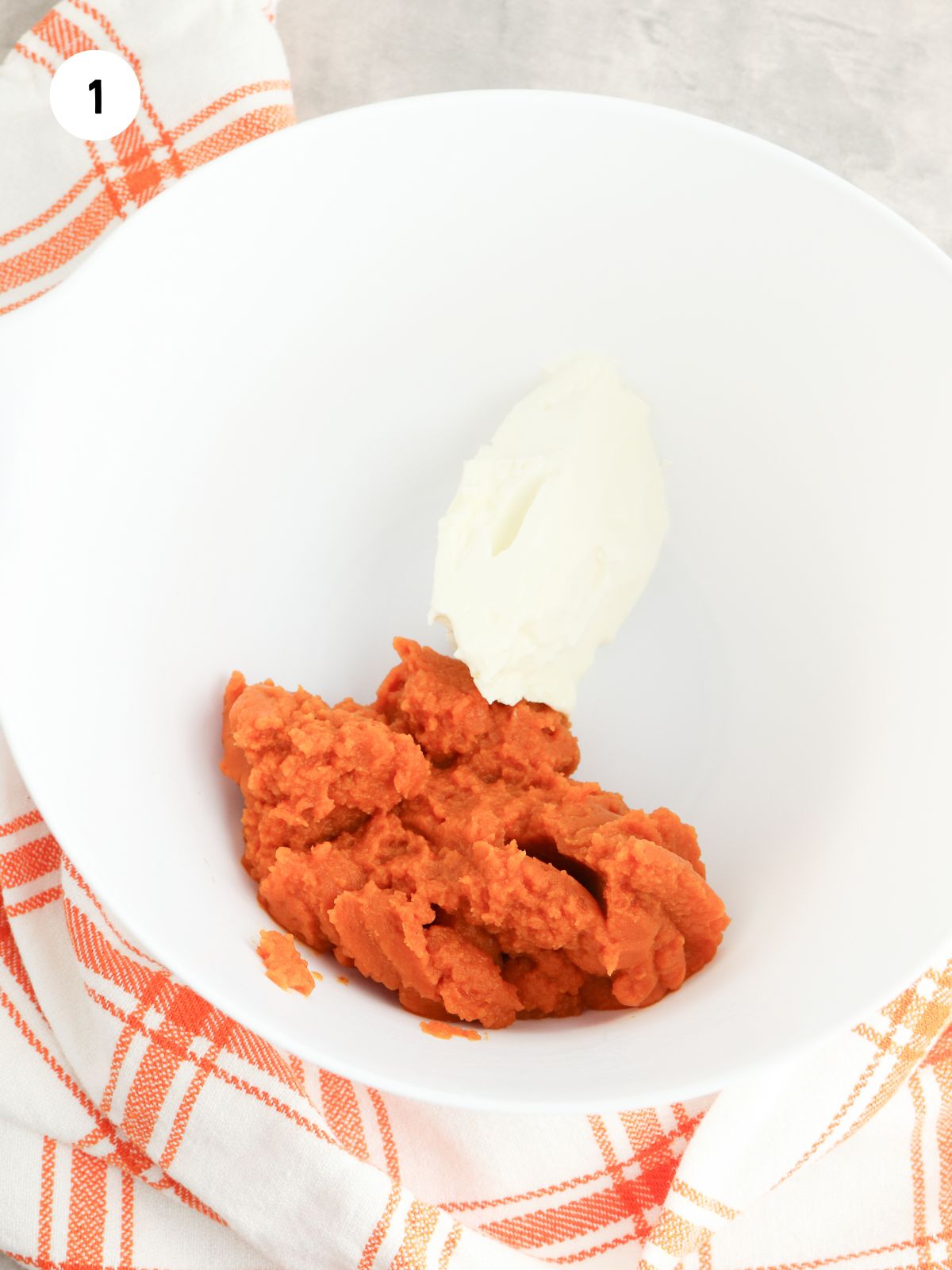 Pumpkin puree and cream cheese in a mixing bowl