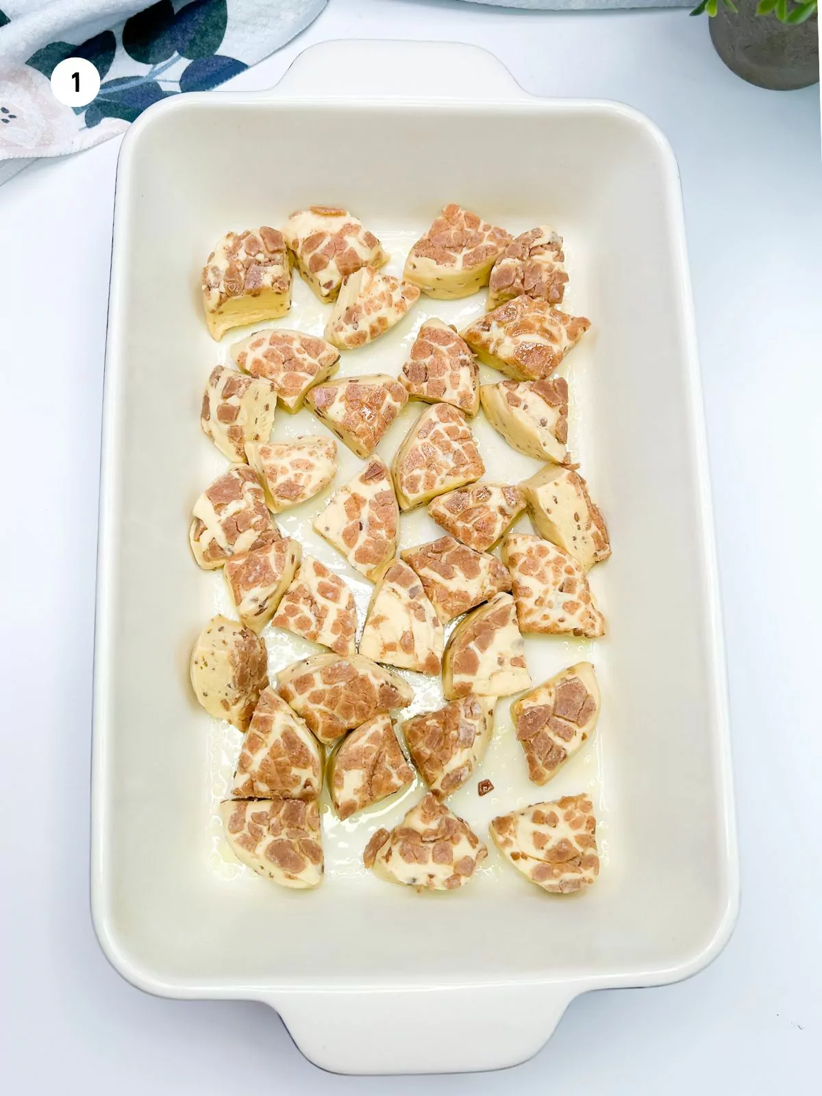 add cut up cinnamon rolls to casserole dish