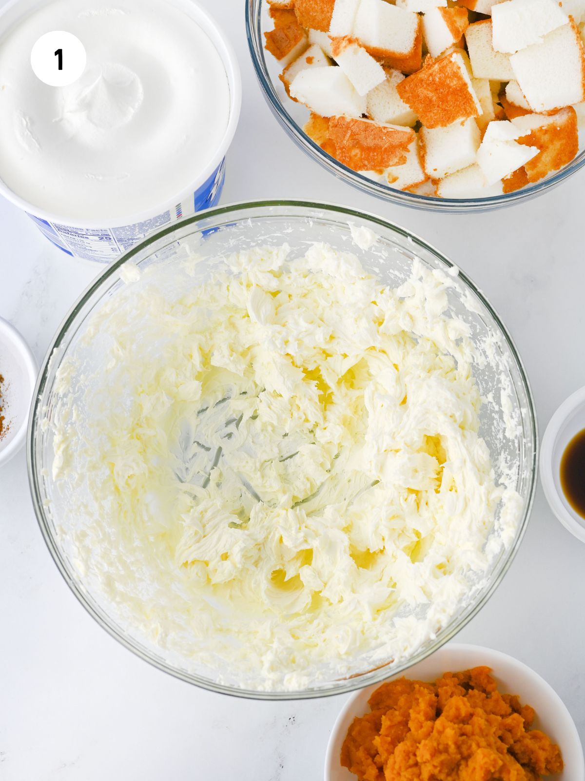 beaten cream cheese in a clear mixing bowl