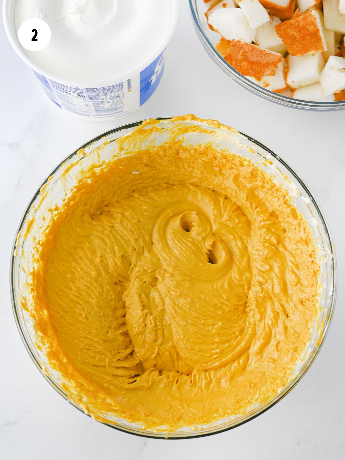 pumpkin cream cheese in a clear mixing bowl