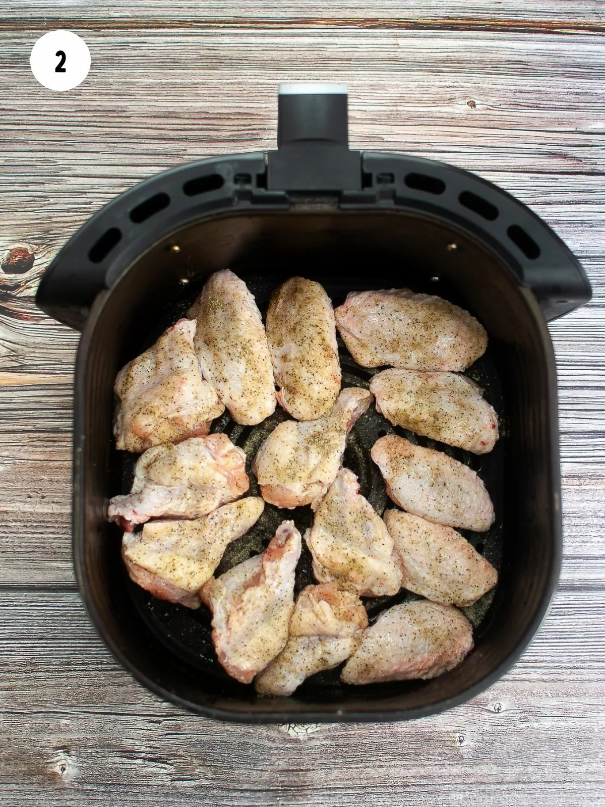 seasoned chicken wings in the air fryer basket