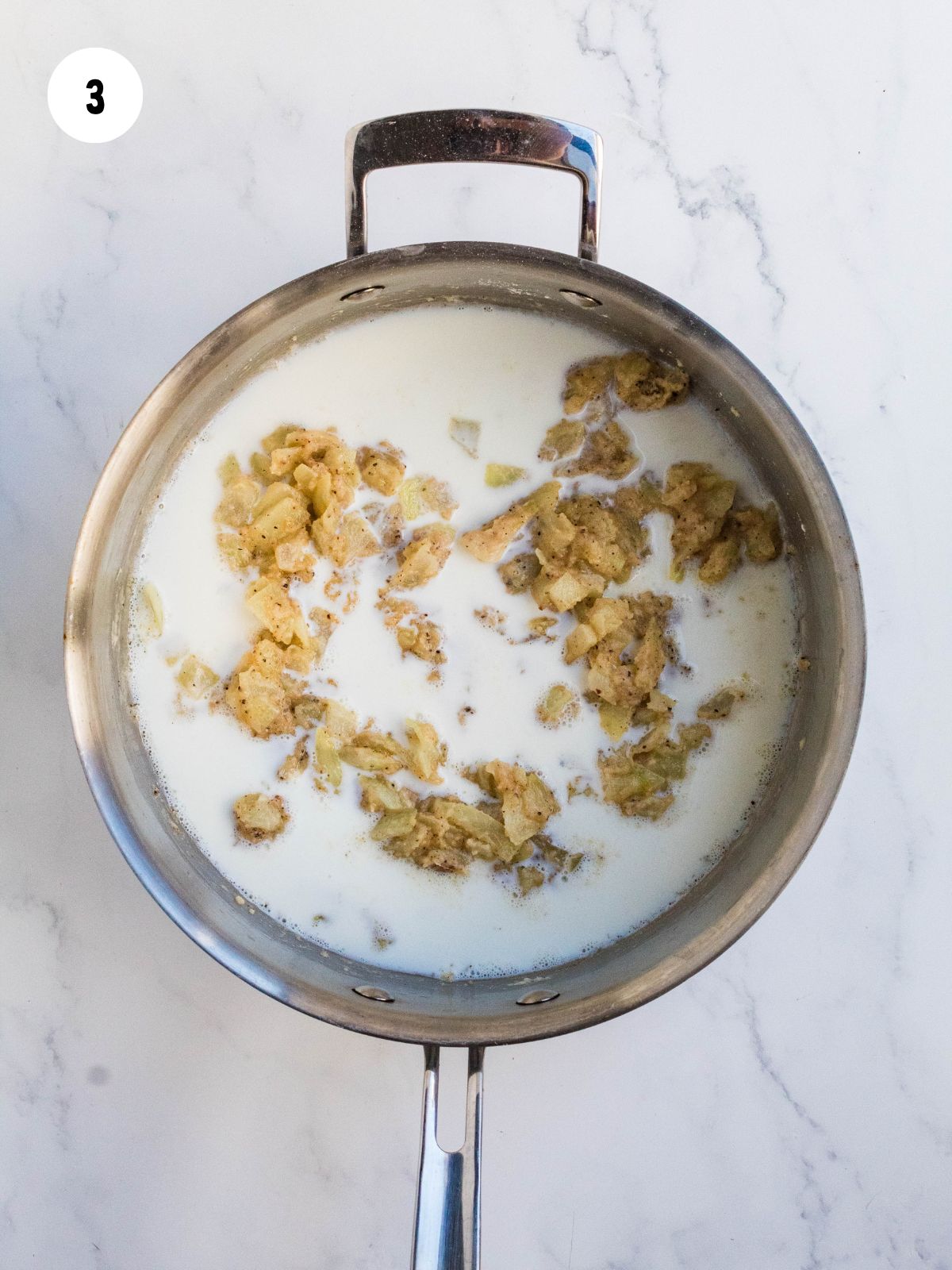 milk and heavy cream added to pan of onions