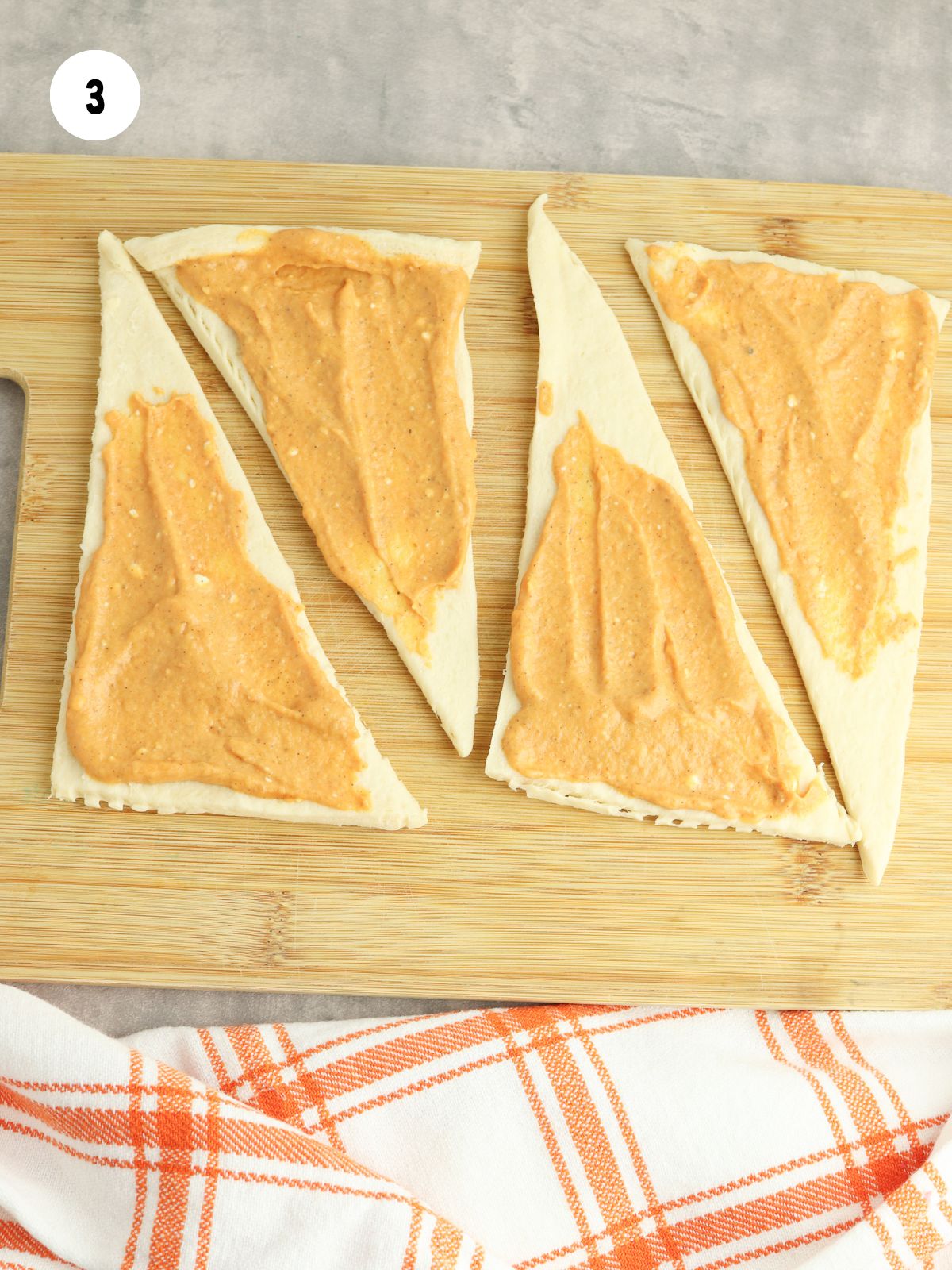 pumpkin cream cheese filling spread onto each crescent dough triangle