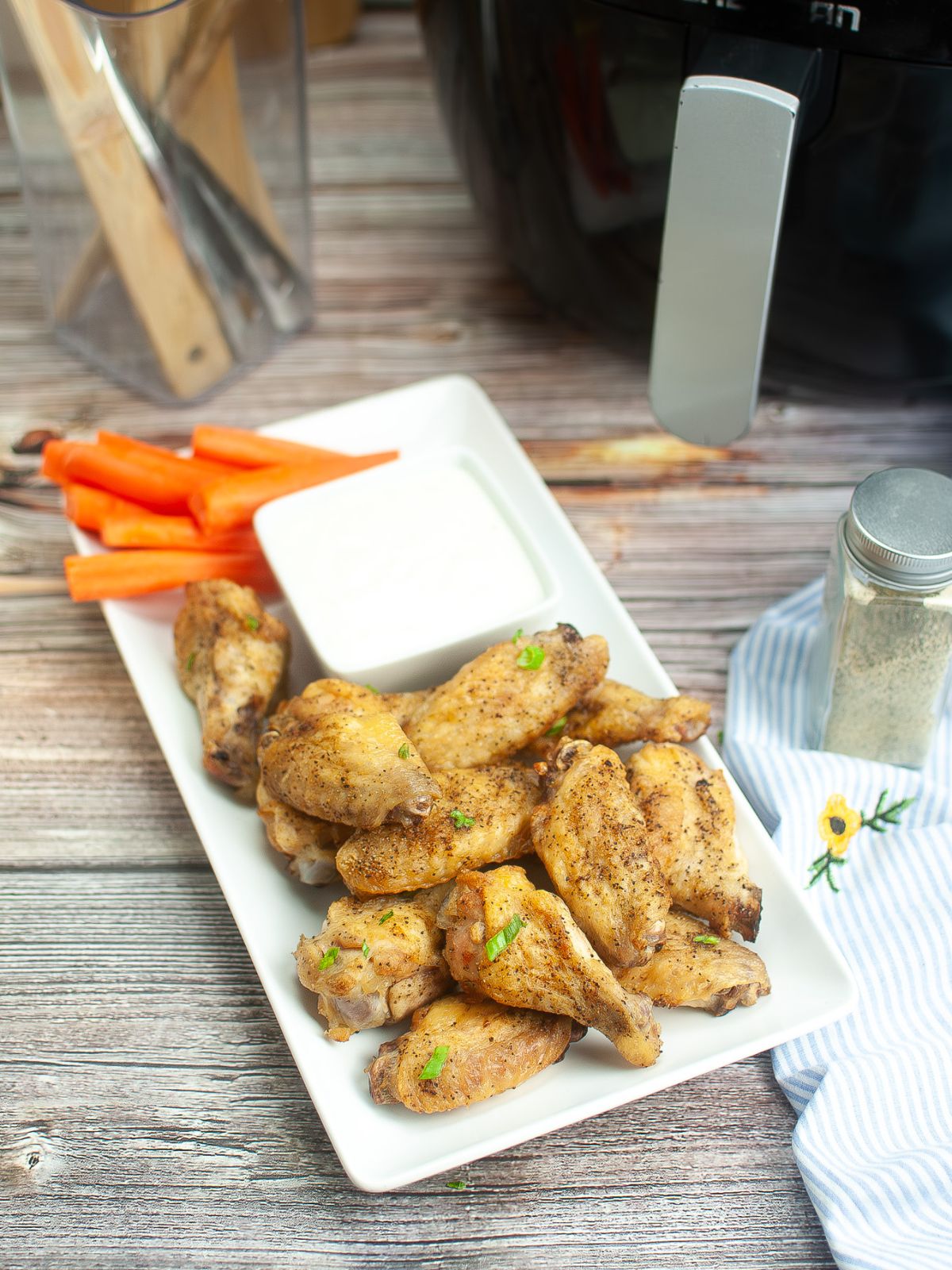 chicken wings served with ranch and carrot sticks