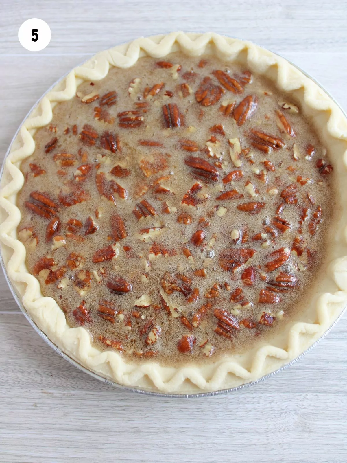 Pecan pie filling poured into an unbaked pie shell