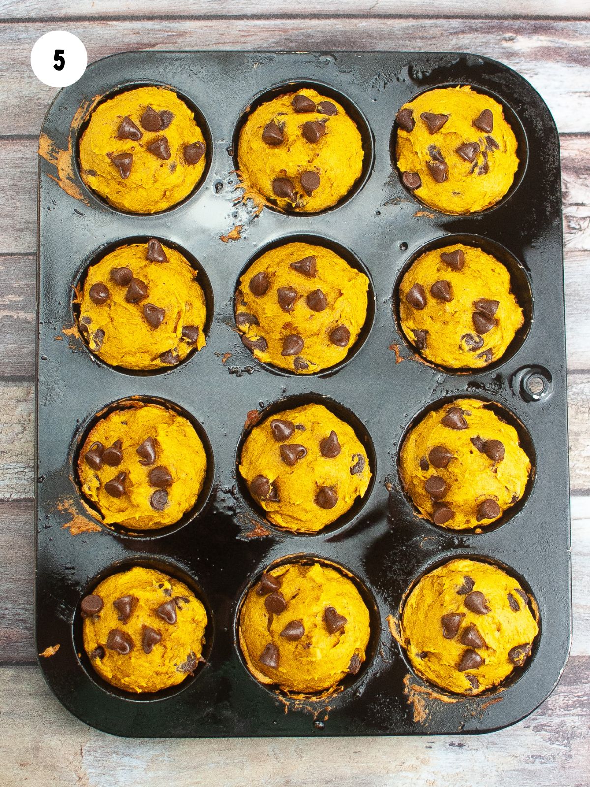 baked chocolate chip muffins in a muffin pan