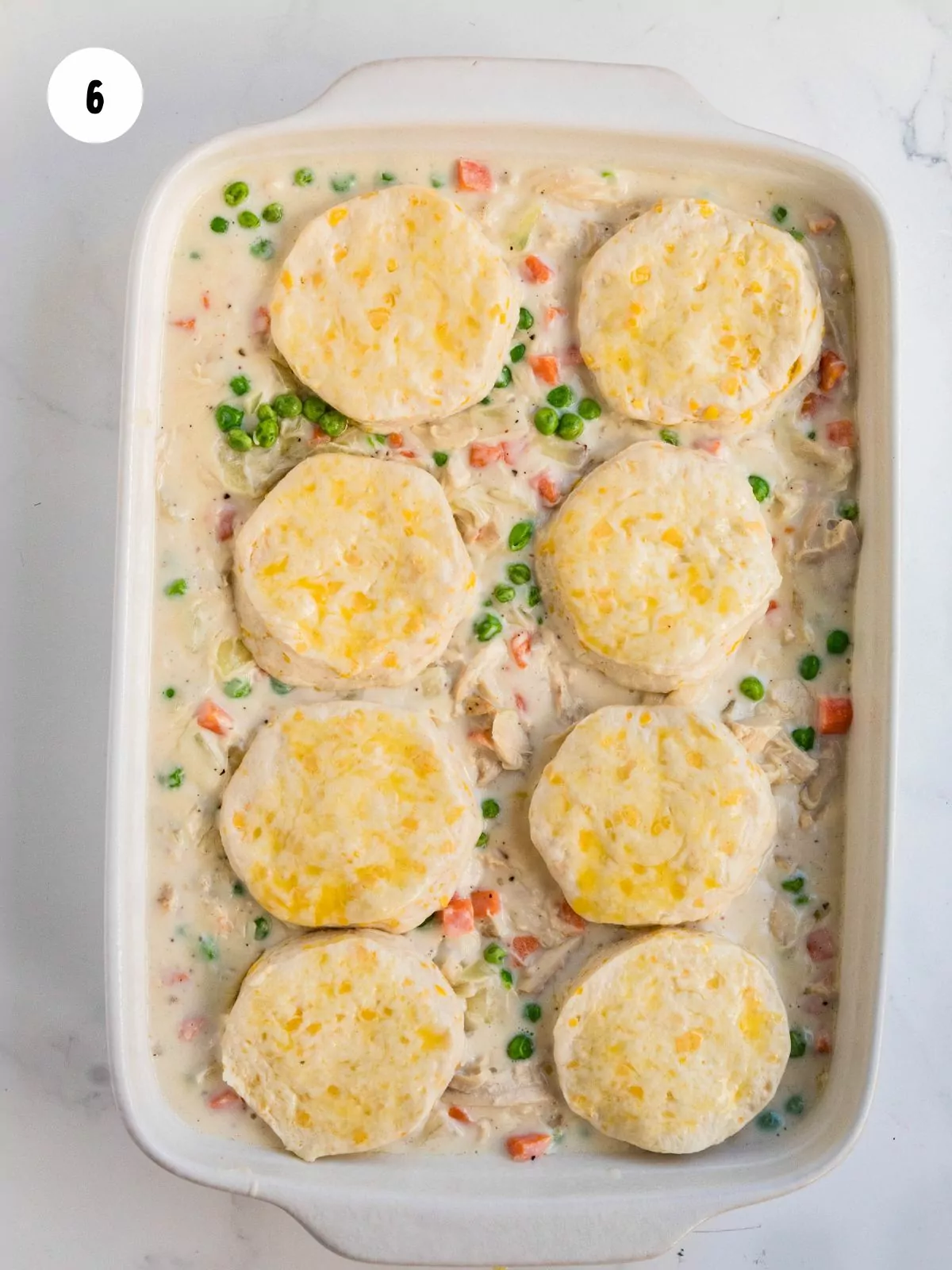 uncooked biscuits added on top of the pot pie mixture