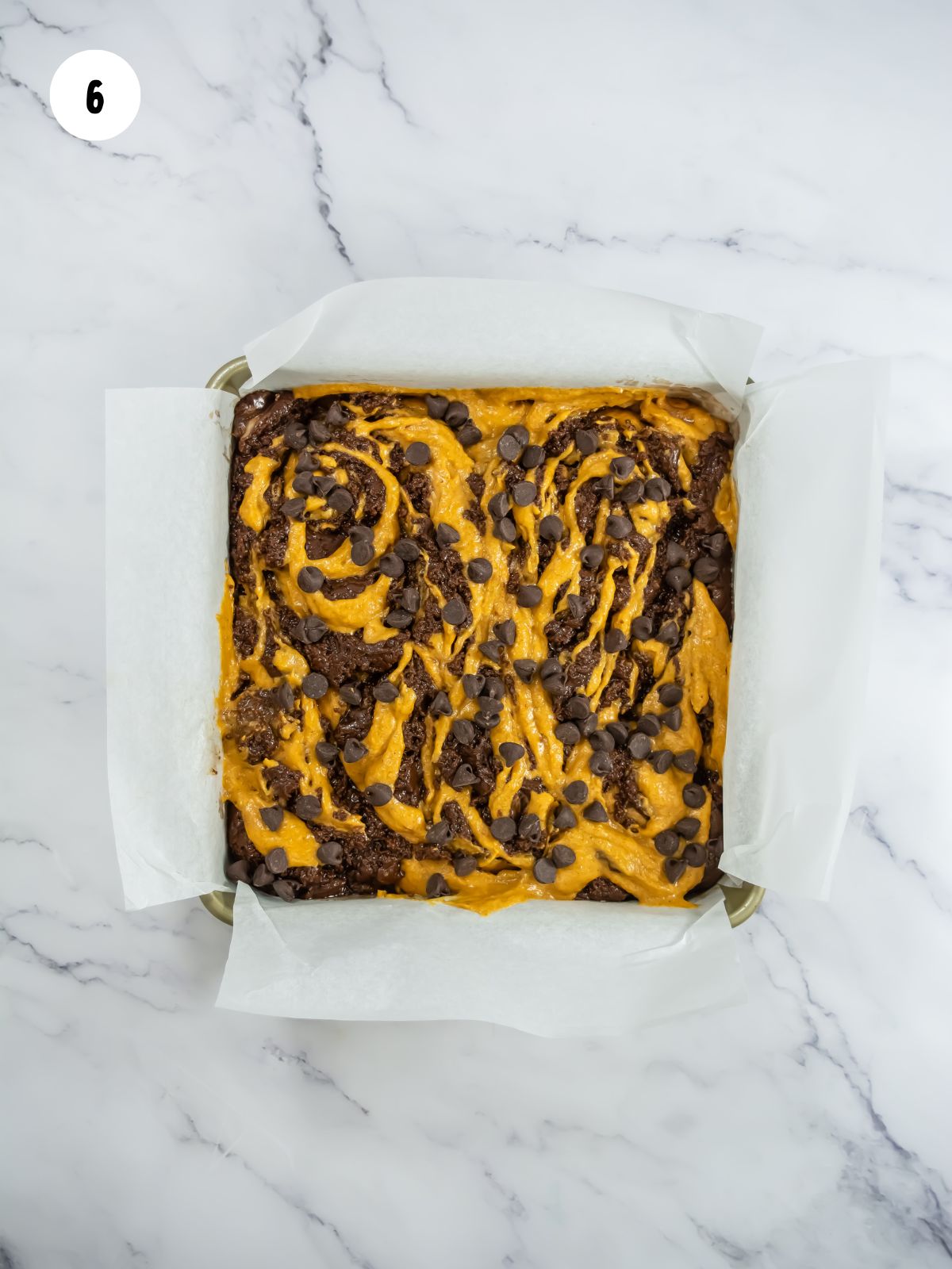 the chocolate and pumpkin brownie batter swirled together. Chocolate chips added on top.