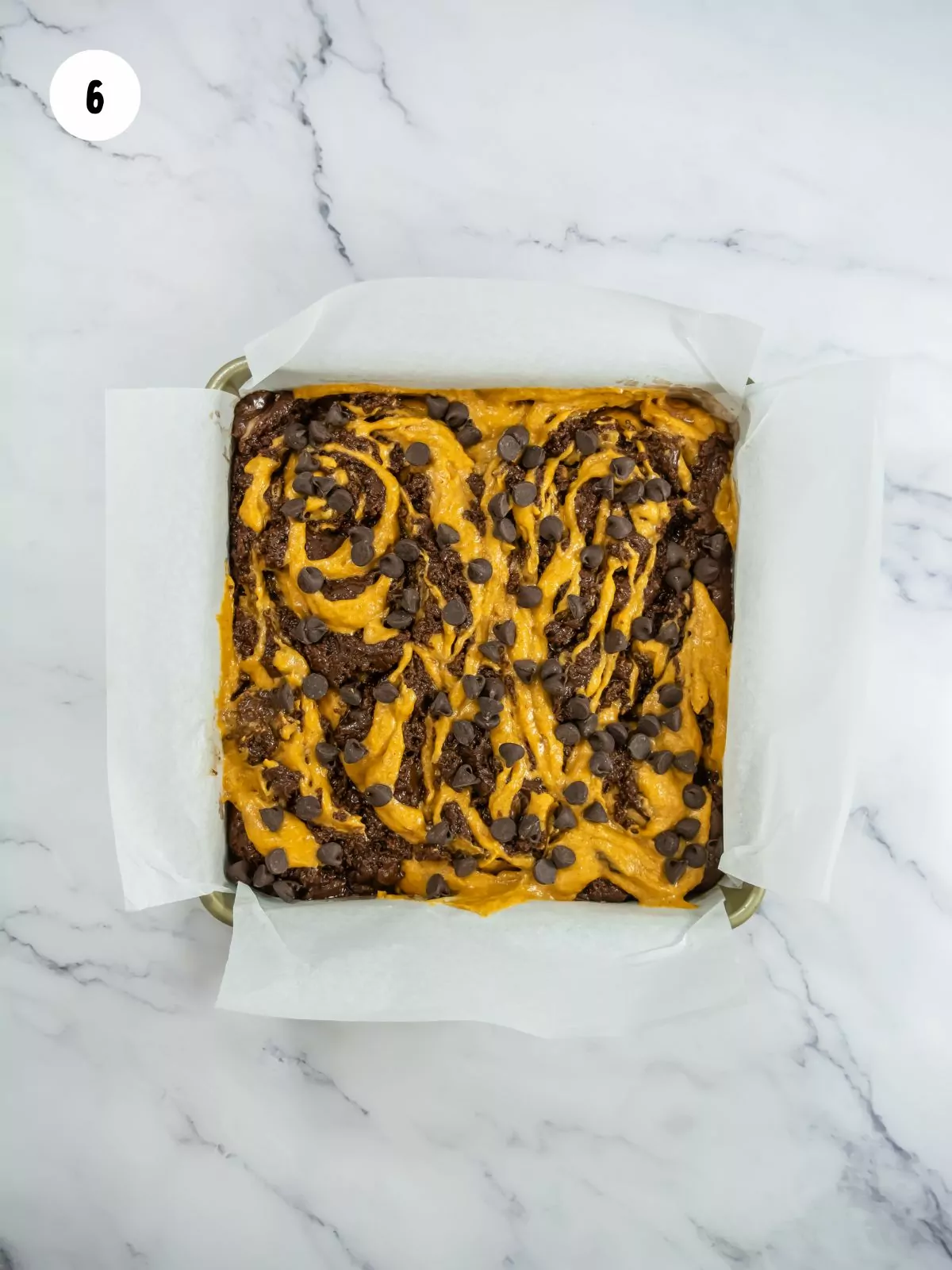 the chocolate and pumpkin brownie batter swirled together. Chocolate chips added on top.