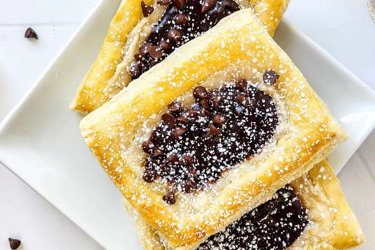 puff pastry top with chocolate and sprinkled with sugar glaze