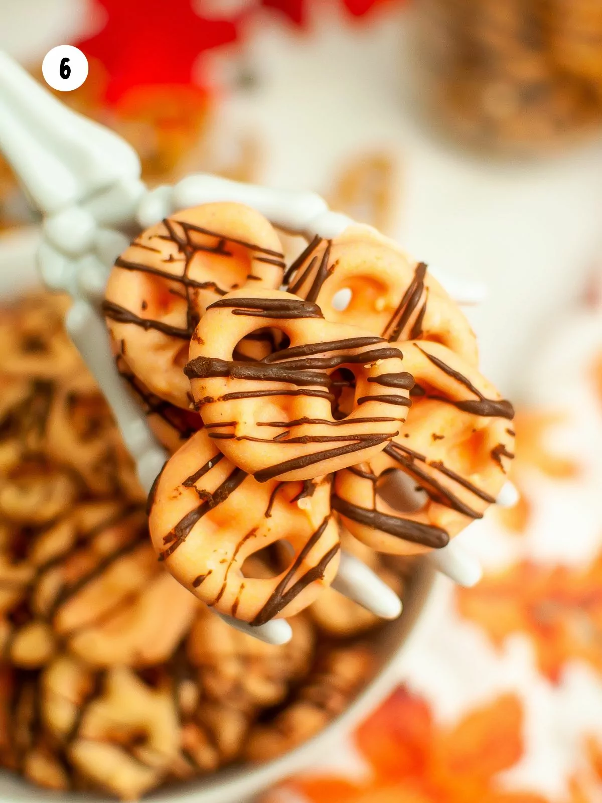 close up of pretzels dipped in orange chocolate.