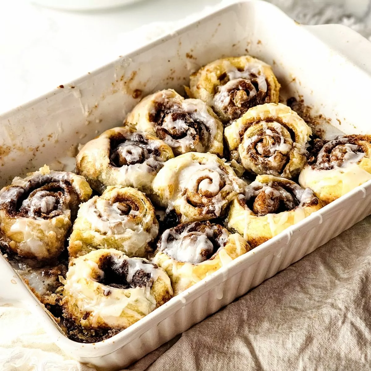 baked Cinnamon Rolls made with Puff Pastry in a white baking dish