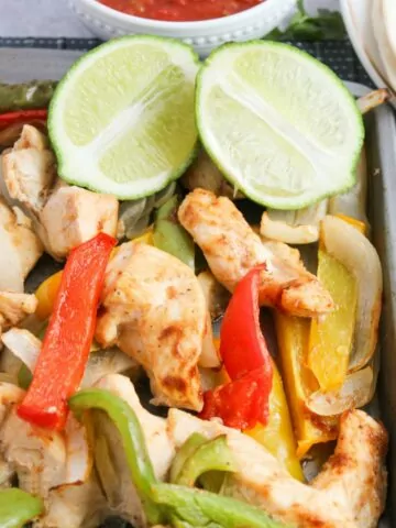 sheet pan fajitas with a lime sliced in half