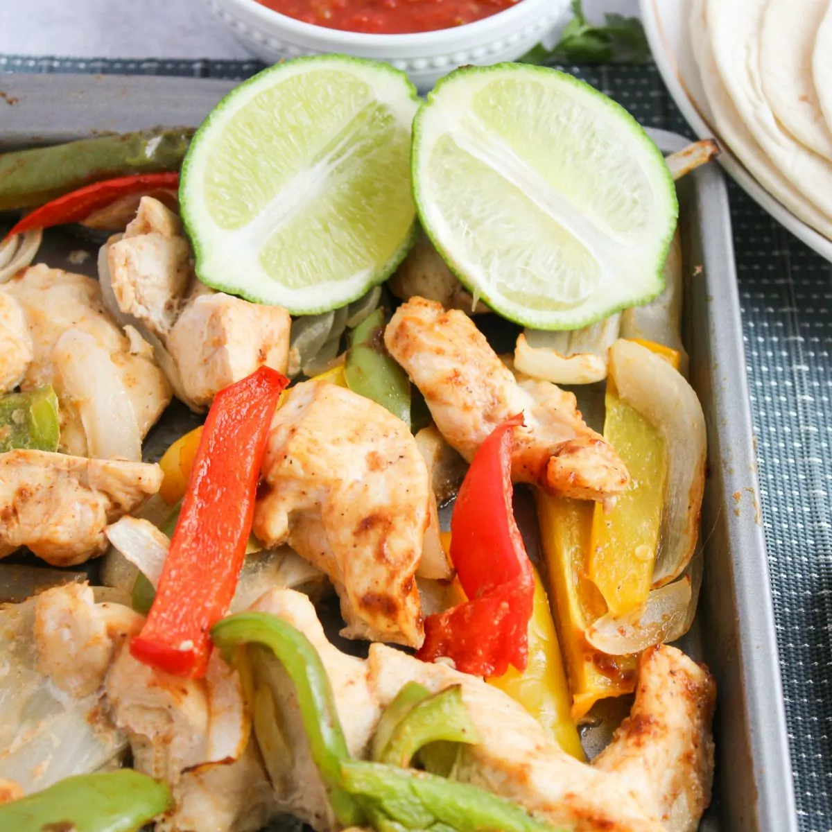 sheet pan fajitas with a lime sliced in half