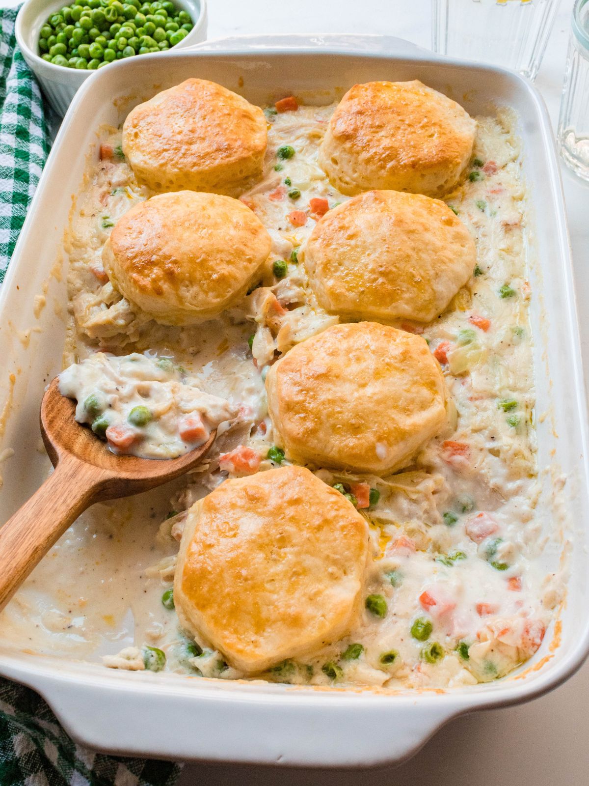 Pillsbury Chicken Pot Pie with Biscuits being scooped with a wooden spoon