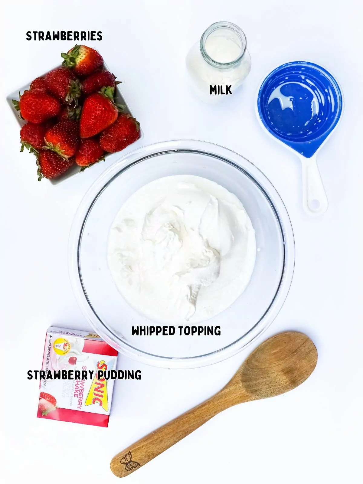 ingredients in bowls, strawberries, whipped topping, pudding mix and milk.