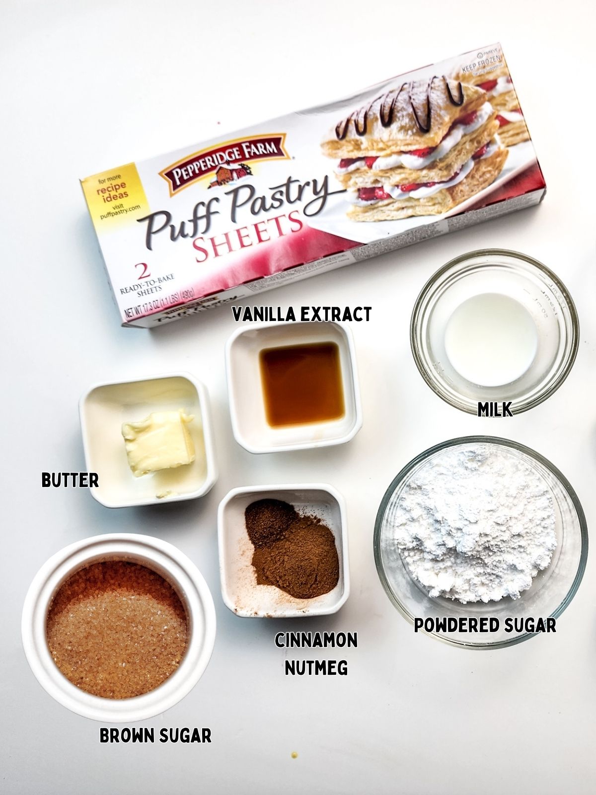 Ingredients, puff pastry, brown sugar, spices, powdered sugar, butter, milk and vanilla extract.