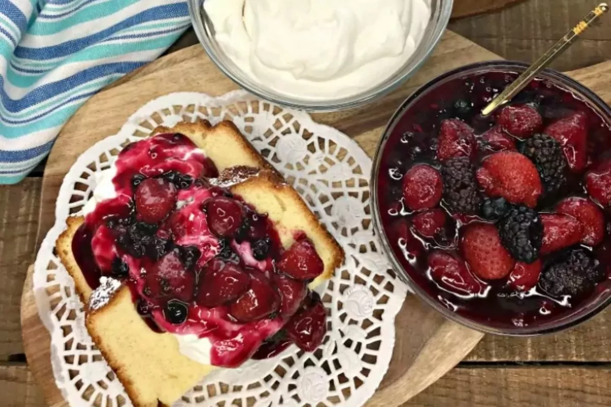 Pound cake slices with mixed berries and whipped cream.