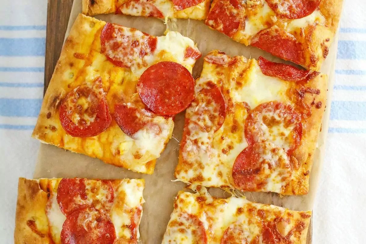 slices of pizza in wooden board