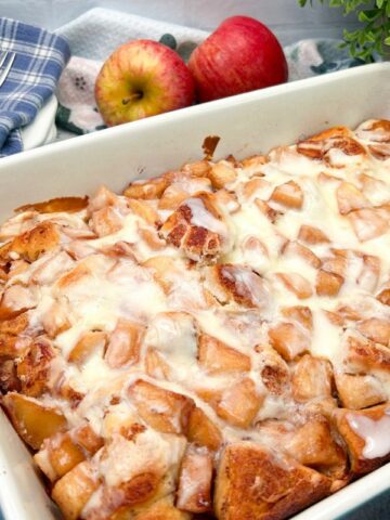 casserole dish with cinnamon rolls and fresh apples.