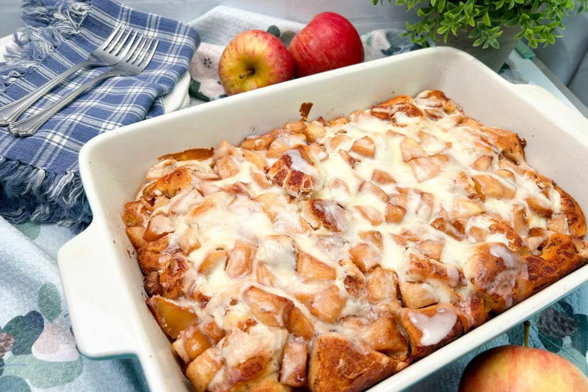 casserole dish with cinnamon rolls and fresh apples.